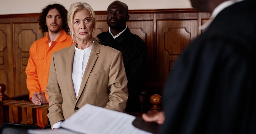 Defendant standing in courtroom while judge reviews case
