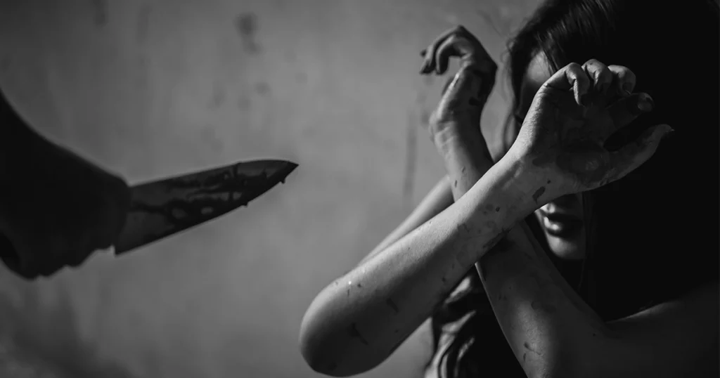 Victim shielding themselves from knife attack.