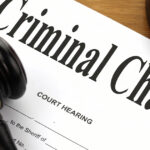 Gavel on criminal charge legal document