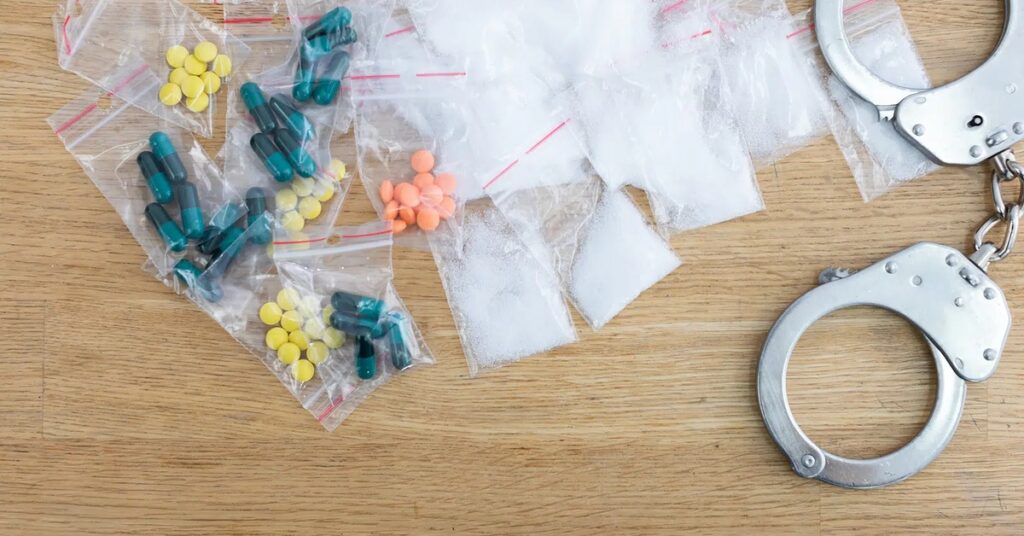 A conceptual legal image with a gavel and handcuffs illustrating the consequences of drug possession in Texas.
