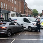 Self-driving car accident with a delivery van in city traffic.