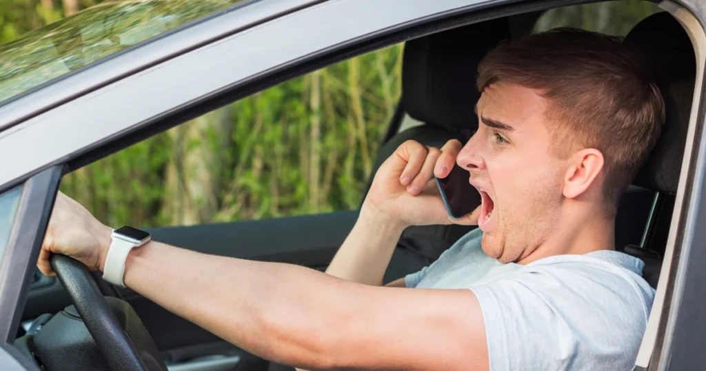 Man driving recklessly while yelling on phone