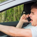 Man driving recklessly while yelling on phone